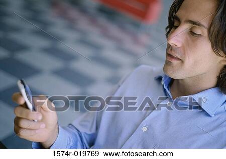High angle view of a businessman operating a mobile phone View Large Photo Image Stock Photo - High angle view of a businessman operating a mobile phone. Fotosearch