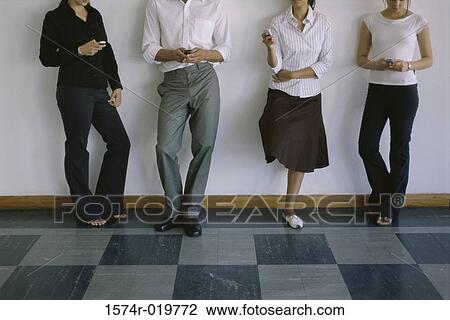 Low section view of three young women and a young man operating mobile phones View Large Photo Image Stock Image - Low section view of three young women and a young man operating mobile phones. Fotosearch