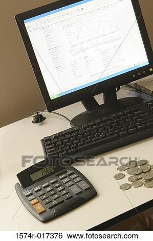 Close-up of a desktop pc with a calculator and coins on a table View Large Photo Image Stock Photograph - Close-up of a desktop pc with a calculator and coins on a table. Fotosearch
