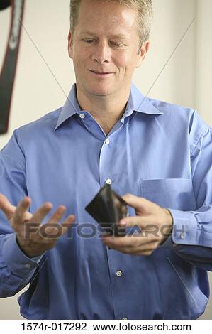 Close-up of a mid adult man holding a wallet View Large Photo Image Stock Image - Close-up of a mid adult man holding a wallet. Fotosearch