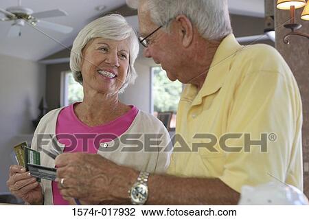 Close-up of a senior couple destroying credit cards View Large Photo Image Stock Image - Close-up of a senior couple destroying credit cards. Fotosearch