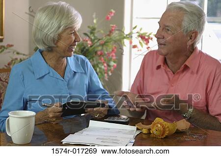 Close-up of a senior couple looking at each other smiling View Large Photo Image Stock Photo - Close-up of a senior couple looking at each other smiling. Fotosearch