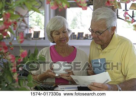 Close-up of a senior couple reading a bill View Large Photo Image Stock Image - Close-up of a senior couple reading a bill. Fotosearch