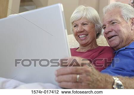 Stock Image - Close-up of a senior couple using a laptop. Fotosearch