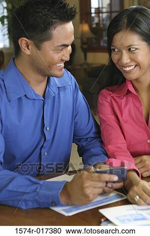 Stock Image - Close-up of a young couple smiling. Fotosearch