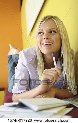 Close-up of a young woman lying on a bench with bills and a calculator in front of her View Large Photo Image Stock Photograph - Close-up of a young woman lying on a bench with bills and a calculator in front of her. Fotosearch