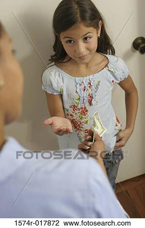 Stock Image - High angle view of a daughter asking her mother for money. Fotosearch