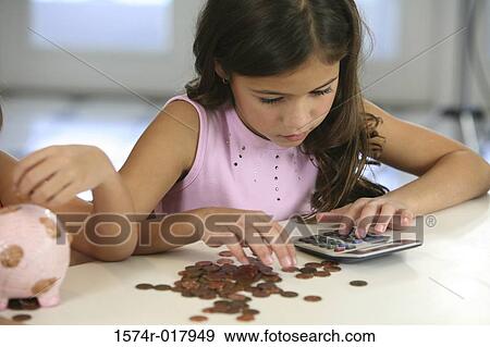 High angle view of a girl counting coins View Large Photo Image Stock Photo - High angle view of a girl counting coins. Fotosearch
