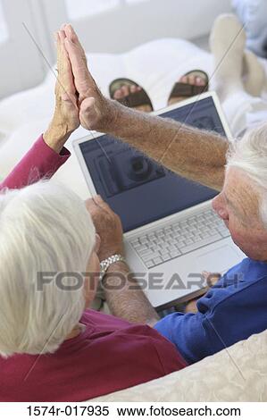 High angle view of a senior couple giving a high five to each other View Large Photo Image Stock Photography - High angle view of a senior couple giving a high five to each other. Fotosearch