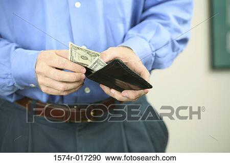 Mid section view of a mid adult man holding a wallet View Large Photo Image Stock Image - Mid section view of a mid adult man holding a wallet. Fotosearch