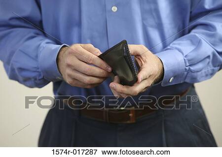 Mid section view of a mid adult man holding a wallet View Large Photo Image Stock Photo - Mid section view of a mid adult man holding a wallet. Fotosearch