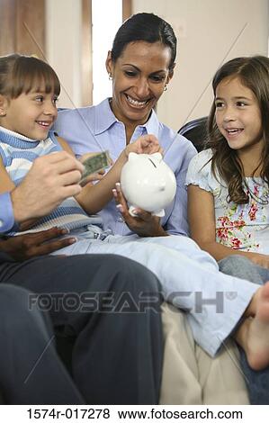 Parents sitting with their two daughters smiling View Large Photo Image Stock Photo - Parents sitting with their two daughters smiling. Fotosearch