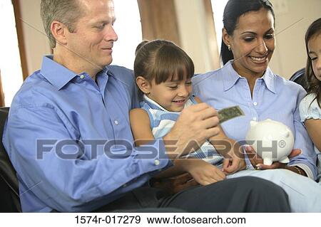 Parents sitting with their two daughters smiling View Large Photo Image Stock Photo - Parents sitting with their two daughters smiling. Fotosearch
