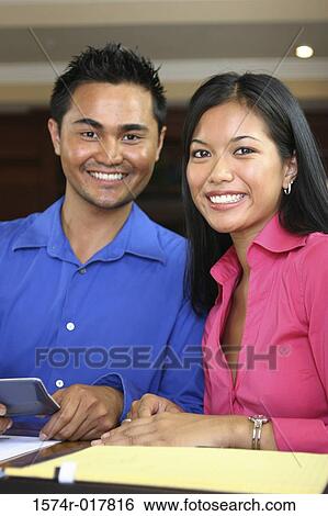Portrait of a young couple smiling View Large Photo Image Stock Photograph - Portrait of a young couple smiling. Fotosearch