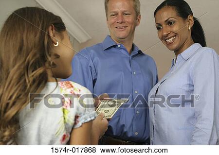 Stock Photo - Rear view of a daughter taking money from her parents. Fotosearch