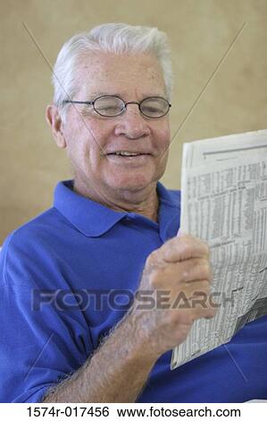 Senior man reading a newspaper View Large Photo Image Stock Photograph - Senior man reading a newspaper. Fotosearch