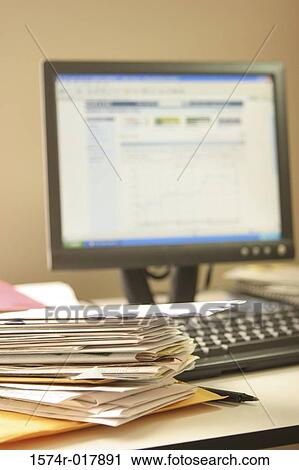 Stock Image - Young woman talking on a mobile phone holding a credit card. Fotosearch