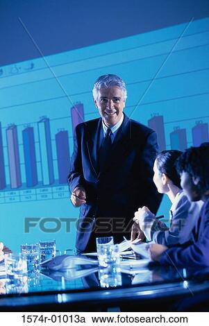 Business executives at a presentation in the conference room View Large Photo Image Stock Image - Business executives at a presentation in the conference room. Fotosearch