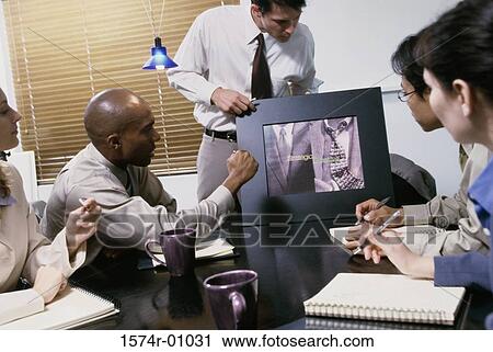 Business executives at a presentation in a conference room View Large Photo Image Stock Image - Business executives at a presentation in a conference room. Fotosearch