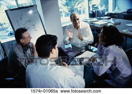 Stock Image - Business executives at a presentation in a conference room. Fotosearch