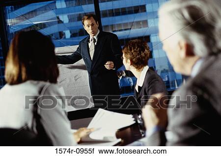 Stock Image - Business executives in a meeting in conference room. Fotosearch