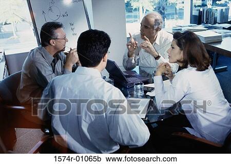 Stock Image - Business executives in a meeting. Fotosearch