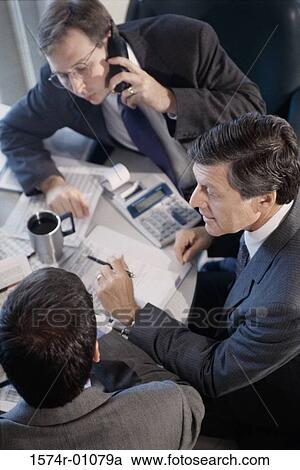 Stock Image - Business executives in a meeting. Fotosearch