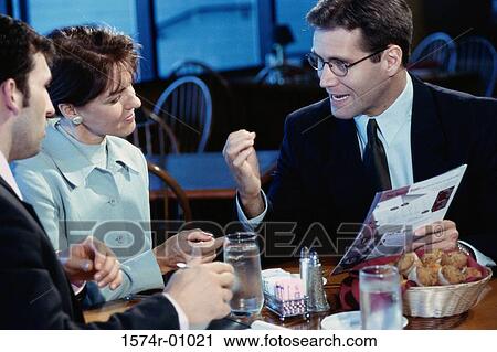 Business executives seated at a restaurant View Large Photo Image Stock Image - Business executives seated at a restaurant. Fotosearch
