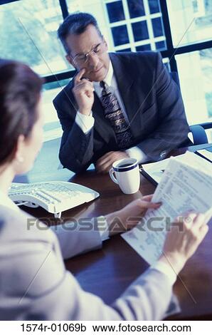 Stock Image - Businessman and businesswoman in a meeting. Fotosearch