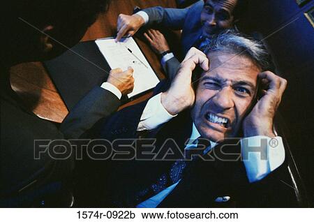 Stock Image - Businessman holding his head in stress. Fotosearch