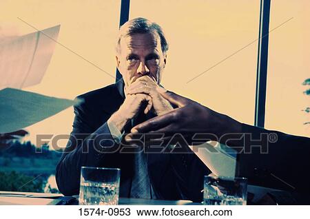Businessman sitting in a conference room View Large Photo Image Stock Image - Businessman sitting in a conference room. Fotosearch