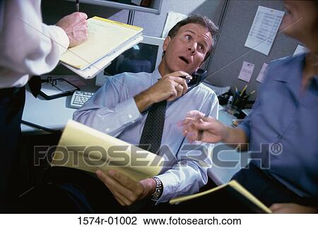 Businessman talking on the landline telephone in the office View Large Photo Image Stock Image - Businessman talking on the landline telephone in the office. Fotosearch