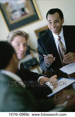 Stock Image - Businessmen having a discussion. Fotosearch