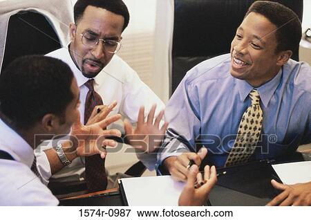 Stock Photo - Businessmen in a meeting. Fotosearch
