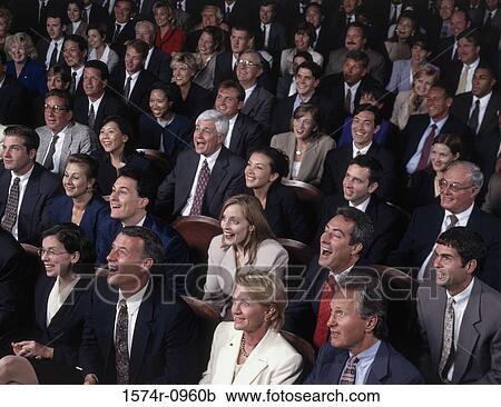 Stock Image - Crowd of business executives together in a hall. Fotosearch