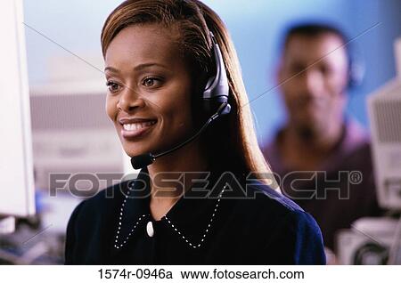 Stock Image - Female customer service representative wearing a headset. Fotosearch