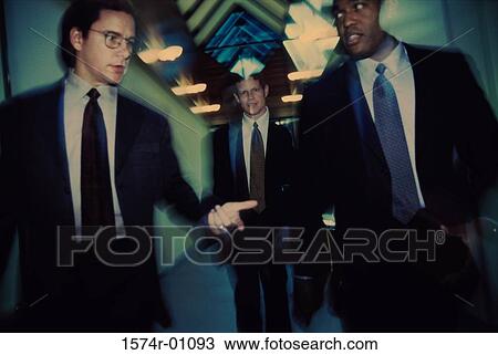 Stock Image - Group of business executives talking to each other. Fotosearch