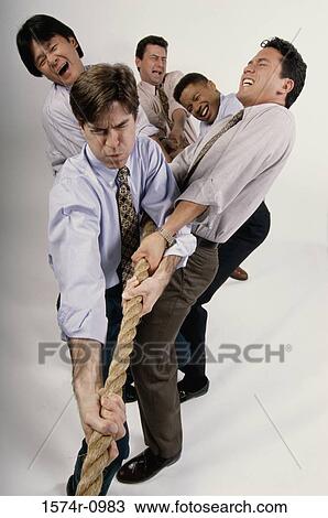 Group of businessmen playing tug-of-war View Large Photo Image Stock Image - Group of businessmen playing tug-of-war. Fotosearch