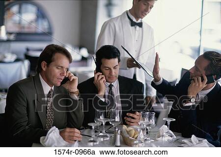 Group of businessmen talking on mobile phones View Large Photo Image Stock Image - Group of businessmen talking on mobile phones. Fotosearch
