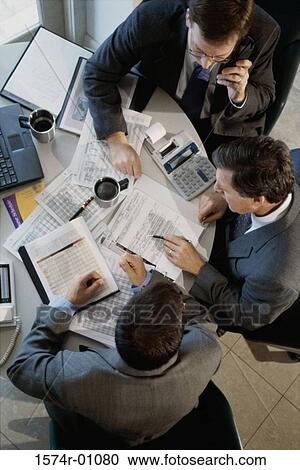Stock Image - High angle view of business executives in a meeting. Fotosearch