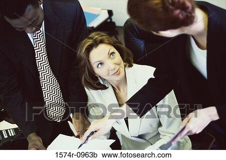Stock Image - High angle view of business executives in a meeting. Fotosearch