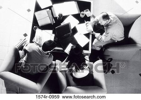 Stock Photo - High angle view of business executives in a meeting. Fotosearch