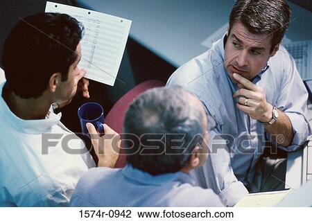 Stock Image - High angle view of businessmen in a meeting. Fotosearch