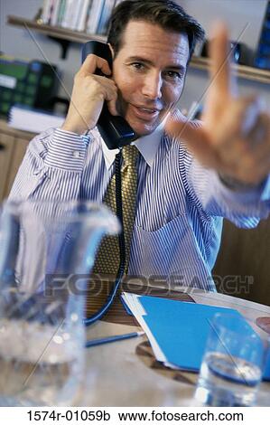 Portrait of a businessman talking on landline telephone View Large Photo Image Stock Image - Portrait of a businessman talking on landline telephone. Fotosearch