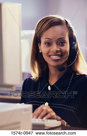 Portrait of a female customer service representative wearing a headset View Large Photo Image Stock Photo - Portrait of a female customer service representative wearing a headset. Fotosearch