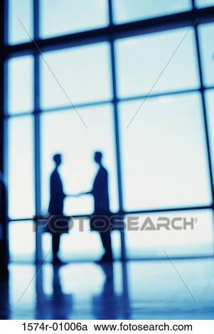 Silhouette of two businessmen shaking hands View Large Photo Image Stock Image - Silhouette of two businessmen shaking hands. Fotosearch