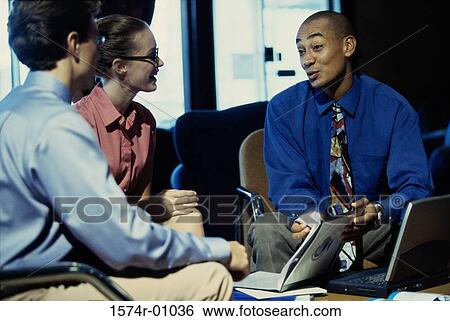 Three business executives discussing in an office View Large Photo Image Stock Photograph - Three business executives discussing in an office. Fotosearch