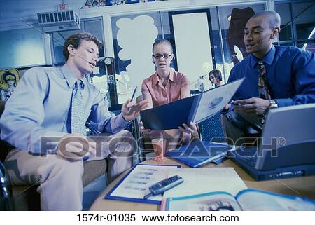 Three business executives discussing in an office View Large Photo Image Stock Photography - Three business executives discussing in an office. Fotosearch