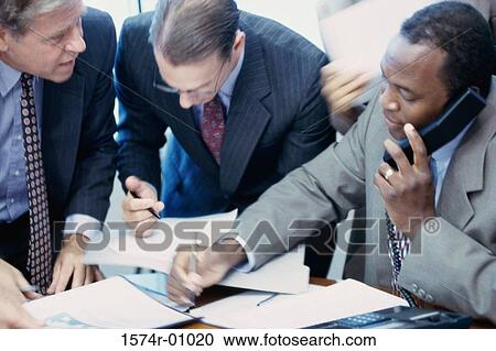 Stock Image - Three businessmen in a meeting. Fotosearch