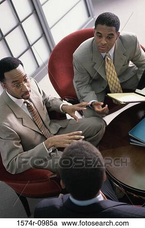 Three businessmen in a meeting View Large Photo Image Stock Image - Three businessmen in a meeting. Fotosearch